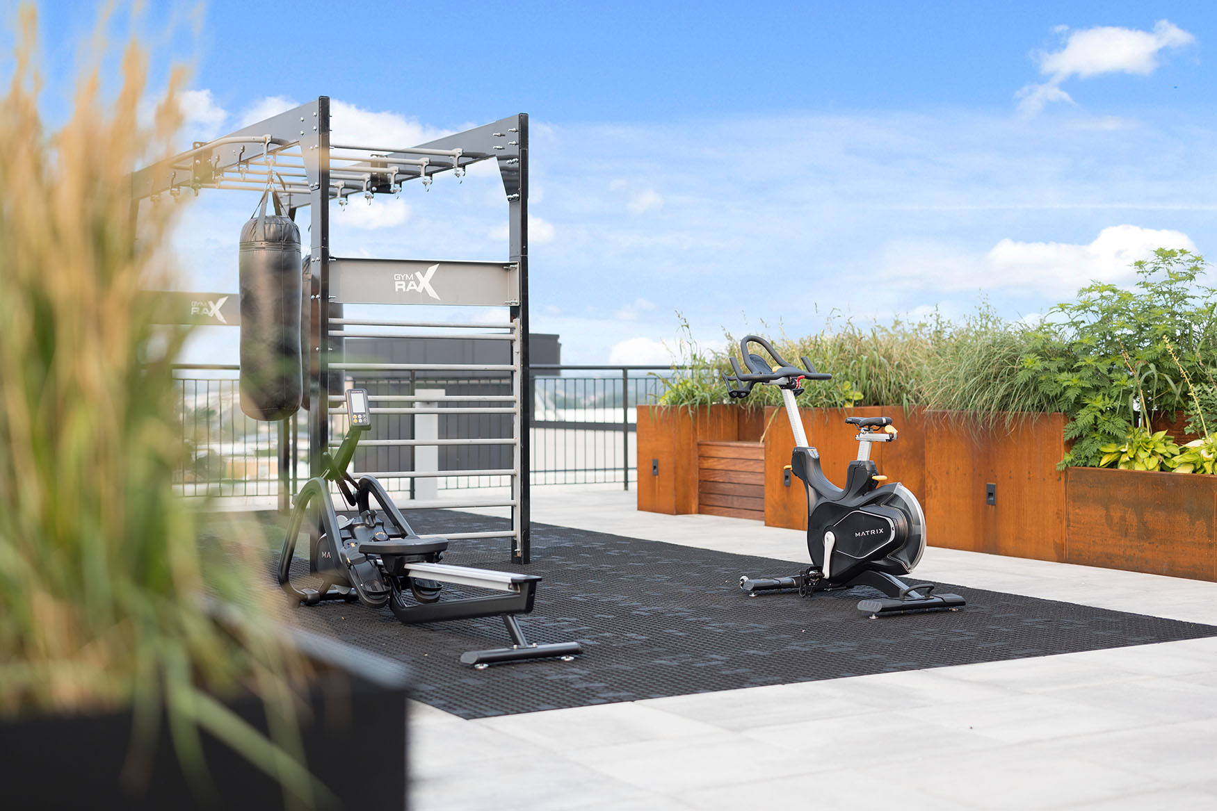 Exercise equipment on rooftop with sky in background